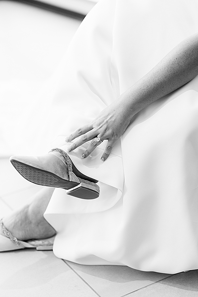 bride touching shoe