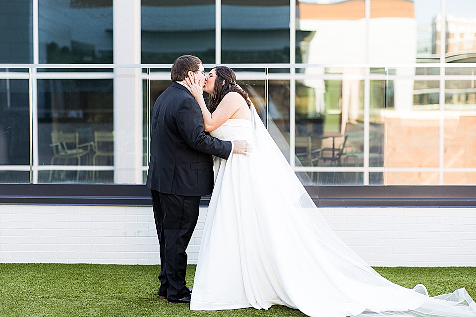 bride and groom kiss during first look