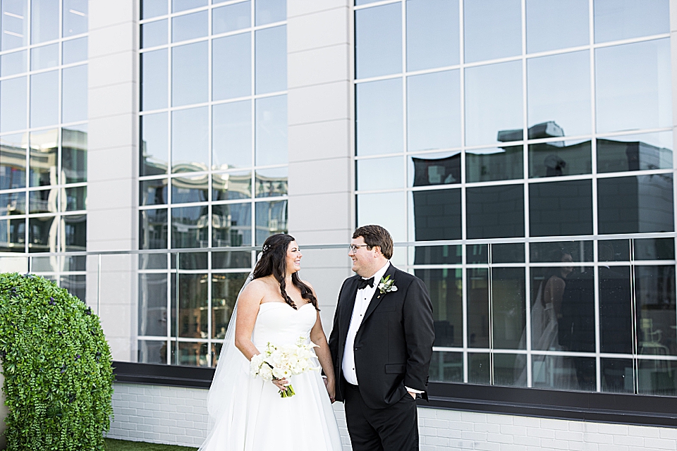 bride and groom looking at one another on Juniper rooftop