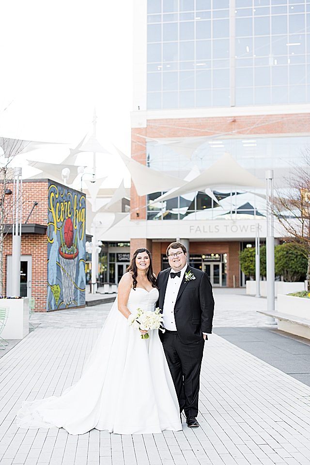 Bride and groom looking at camera downtown greenville
